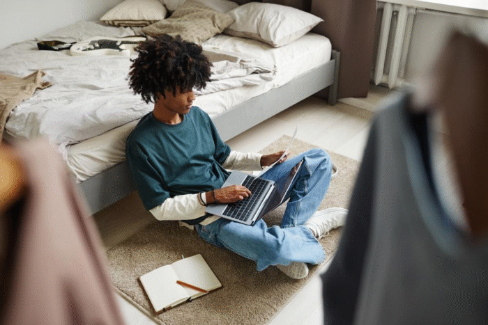 African-American teenager studying on the floor